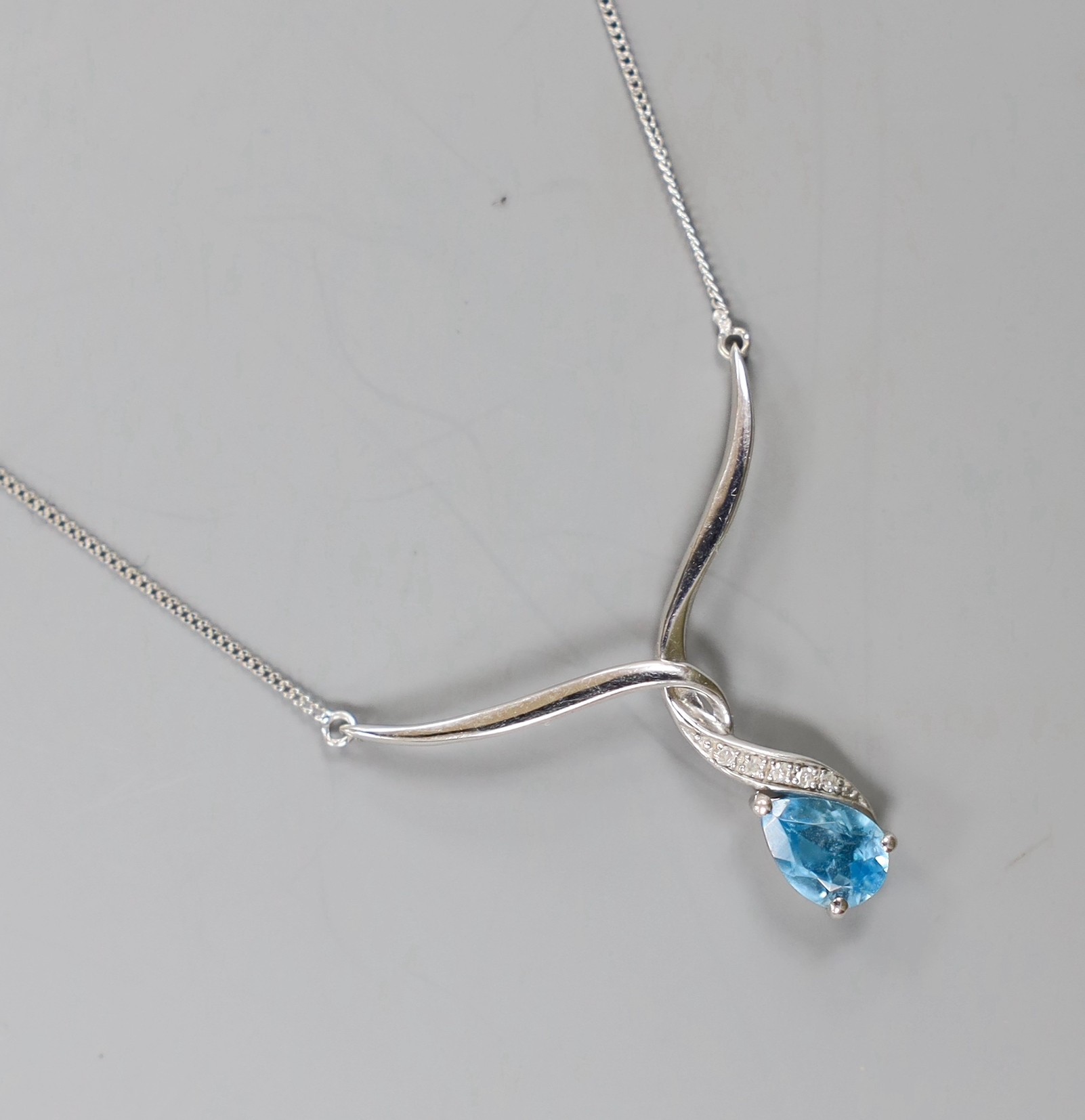 A modern 9ct white gold, blue topaz and diamond set pendant, ten assorted modern 9ct and gem set rings, a yellow metal and opal ring and a quartz set pendant.